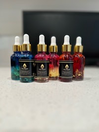 five bottles of cbd oil sitting on a counter