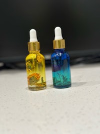 two small bottles of essential oils on a table